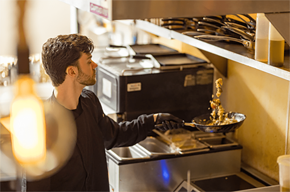 Hemophilia A patient, Rex Herald, in a restaurant kitchen cooking