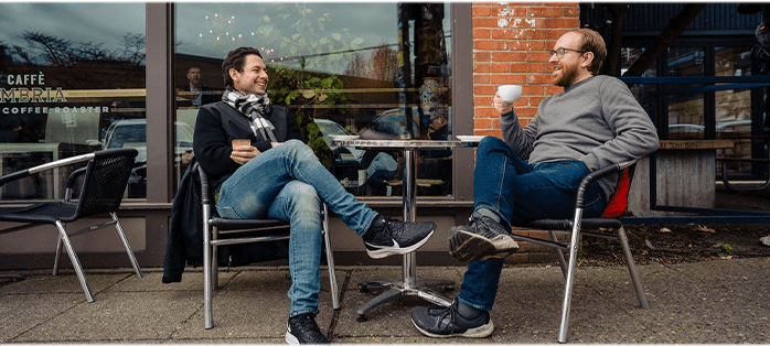 Hemophilia A patient, Billy Eshleman, having a discussion at an outdoor dining table.