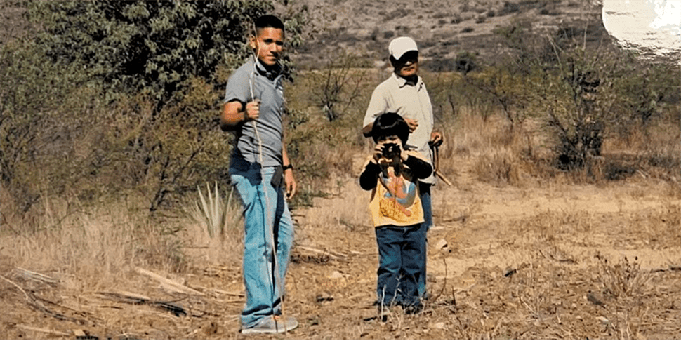 Hemophilia A Patient, Daniel Cruz, holding a stick and hiking with his brother and father
